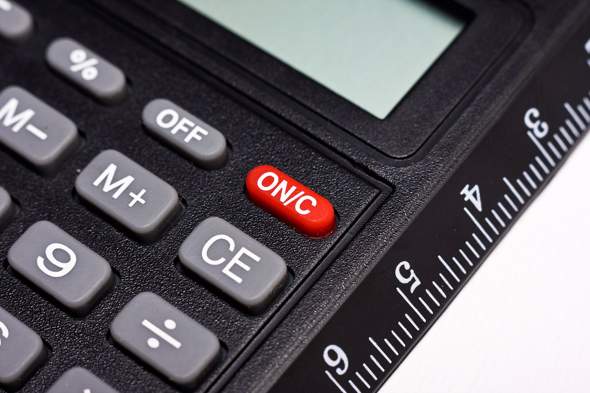 Close-up of calculator keys and a ruler